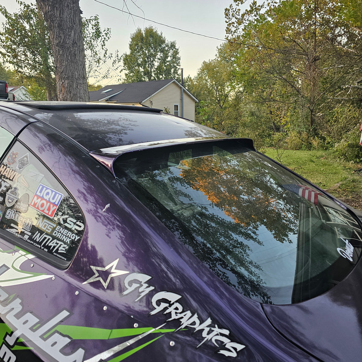 Painted rear window spoiler installed on a purple 2003–2007 Infiniti G35 Coupe